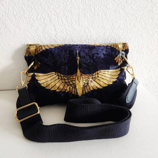 Small Black and Gold Heron Crossbody Bag - Holt x Palm -  The Black and Gold Heron Crossbody Bag is a beautiful piece to add on your hip. It's slightly smaller than the larger version however still packs a punch. The vintage vibes and crushed velvet exterior offer a touch of elegance, while the large inside pocket and gold velvet lining provide practicality. Made with high-end swivel hardware and an Italian metal zipper closure for a sophisticated finish. *Dimensions approximately 6" H x 9.5" W.