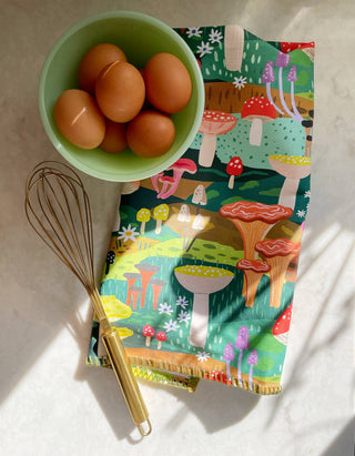 Mushroom Heaven Tea Towel - Holt x Palm -  Our vibrant tea towels are just the thing to add a touch of colorful flair to your kitchen, or a thoughtful hostess/housewarming gift! Woven from 100% absorbent cotton and printed with our charming, hand-painted designs, each towel is embellished with contrasting embroidery along the seaming. • 21″ X 28″ • HANGING LOOP • EMBROIDERED TRIM