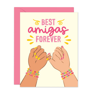 Best Amigas Forever - Holt x Palm -  Show your BFF how much they mean to you with our Best Amigas Forever Friendship Bracelet card! Let them know they're your ride or die, your partner in crime, and your ultimate bestie. A heartfelt reminder of your unbreakable bond. (BFFs for life!) • Folded Card, 4 1/4 x 5 1/2" (A2 Size) • Blank Inside • Includes pink Envelope • Printed on white FSC certified 130