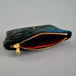 Emerald Zebra Bolt Pouch - Holt x Palm -  This Bolt Pouch is made from high-quality Italian leather with a hair-on pewter zebra effect. It features a stylish gold bolt accent. It is lined with plush rust velvet and has a heavy-duty Italian zipper for added durability. The pouch also includes a small interior pocket for extra organization. Approximate dimensions: 7.75" W x 6" H. Handcrafted in the USA