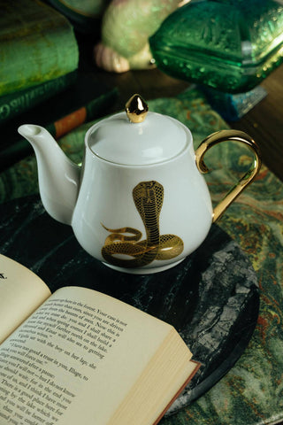 The Most Adorable Cobra Teapot w/ Gift Box - Holt x Palm -  Sippin' tea never looked so cool! Check out our ceramic 24K gold laced Cobra tea-pot...pair this beauty with one of our Poison or Queen tea cups and you have the most unique and unexpected gift for someone amazing...or yourself :-). You deserve it! Plated 24K gold material from Germany. 6" H (including lid) 6" L (handle to spout) 5" W.