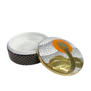 Cobra Rising Ceramic Trinket Box - Holt x Palm -  Not just any storage box, this Cobra Rising Ceramic Trinket Box is super cute and perfect for all your small items. The cobra design adds an awesome touch to this glass box, making it a must-have for any quirky collector. 4.5" Dia, 1.5" H Decorated with 22 kt gold. High-fired porcelain with gold accents Removable lid Boxed for gifting or storing