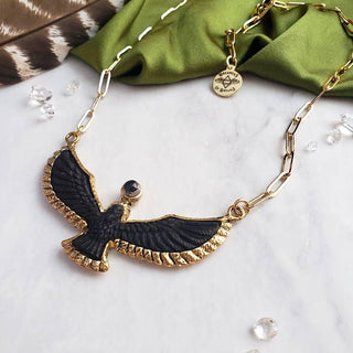 Carved Ebony Bird Necklace - Holt x Palm -  Each bird carving is unique and one of a kind, set in high quality brass. A reminder of having a higher consciousness perspective on life. Mind your way and stay focused. Crowning the bird is a Quartz Crystal Sphere Moon symbolizing your spiritual intuition and connection with life. Adjustable 14k gold plated brass 20" chain