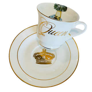 The Queens Tea Cup w/ Gift Box - Holt x Palm -  Regale yourself in the luxury of our newest collection of fine Bone China from Spitfire Girl. Do you want to treat her like the Queen she is? Or treat yourself because you are a Queen that only deserves the best. All Teacups come with a cup and saucer and are packaged in an elegant blue gift box with 24K gold accents. Plated 24k gold material from Germany Dishwasher safe Cup measures 6" Cup 3.5" w 3.10 h