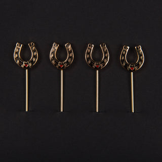 Western Horseshoe Cocktail Picks - Holt x Palm -  Whether you like it a little bit country or a little bit on the rocks, these snazzy picks make a great way to stick your garnish. Topped with a sweet little western horseshoe for good luck whilst imbibing. Includes four gold picks with black and red enamel finish, packaged in our custom printed box. Approximate dimensions: 4” long pick with 0.5 x .625” horseshoe. Hand Wash