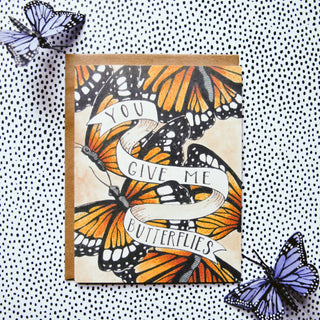 You Give Me Butterflies Card - Holt x Palm -  • Greeting Card Illustrated by Cayla Mattea Zeek • Created in Lafayette, Louisiana USA • A2 Card Measures 4.25" x 5.5" Folded • Blank Inside • Printed on Post Consumer Waste Recycled Heavy Card-Stock Paper • Recycled Kraft Brown Envelope • Eco Clear Plant-Based PLA (Polylactic Acid) Sleeve, Commercially Compostable