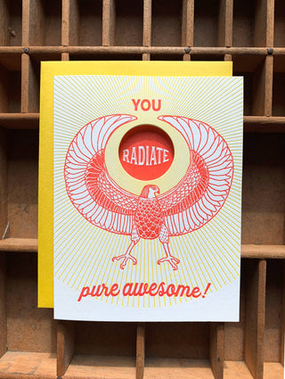 You Radiate Pure Awesome Card - Holt x Palm -  "Spread smiles and pure awesome vibes with this playful greeting card. Perfect for showing your rad friends and loved ones how much they mean to you. Get ready to make someone's day!" • blank inside and measures 4.25”x5.5” folded • folded card is letterpress printed in warm red and yellow ink on 100% cotton paper • with circle die cut on front • accompanied by an A2 yellow envelope