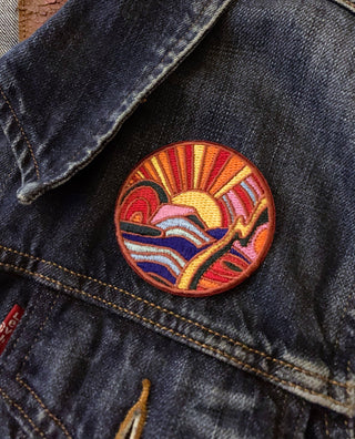 Circle Oasis - Iron On Patch - Holt x Palm -  I dunno where this oasis is, but it has sunshine, purple mountains, a rainbow shaped thingy, waves, and like, a soft lightning bolt type thing. Looks like a good time! Iron-on patch, measures about 2.5 X 2.5 Inches round.