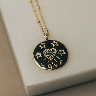 Eye Love You Heart engraved 18k Gold Plate Necklace - Holt x Palm -  Super cute necklace perfect for layering. Round charm with heart and eye emblem and the word "love" surrounded by stars. Perfect little gift for someone you love.Materials: 18k gold plated 925 sterling silver. Zircon stone. Length of Chain: 16.25-18.25 inches