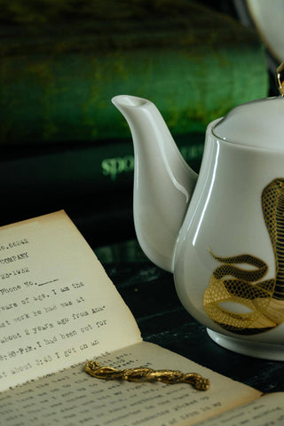 The Most Adorable Cobra Teapot w/ Gift Box - Holt x Palm -  Sippin' tea never looked so cool! Check out our ceramic 24K gold laced Cobra tea-pot...pair this beauty with one of our Poison or Queen tea cups and you have the most unique and unexpected gift for someone amazing...or yourself :-). You deserve it! Plated 24K gold material from Germany. 6" H (including lid) 6" L (handle to spout) 5" W.