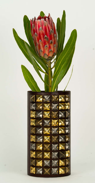 "The Rockstar" Luxury Leather Wrapped Vase - Holt x Palm -  Beautifully wrapped in fine leather and adorned with 60 multi-colored solid brass studs. Named the "Rockstar" its got attitude, swagger and sexy as hell! Each piece is meticulously hand studded to order. We use 4 solid brass "button" posts to fasten the leather to the glass vessel, the leather wrap is removeable for cleaning. 8" tall x 4" wide