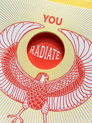 You Radiate Pure Awesome Card - Holt x Palm -  "Spread smiles and pure awesome vibes with this playful greeting card. Perfect for showing your rad friends and loved ones how much they mean to you. Get ready to make someone's day!" • blank inside and measures 4.25”x5.5” folded • folded card is letterpress printed in warm red and yellow ink on 100% cotton paper • with circle die cut on front • accompanied by an A2 yellow envelope