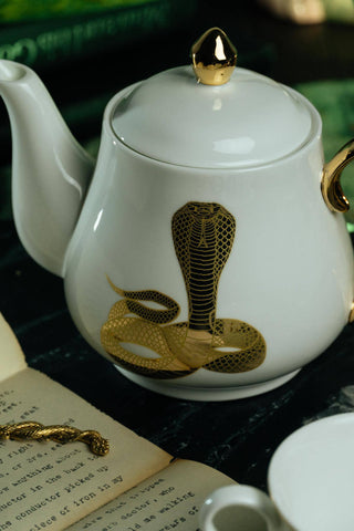 The Most Adorable Cobra Teapot w/ Gift Box - Holt x Palm -  Sippin' tea never looked so cool! Check out our ceramic 24K gold laced Cobra tea-pot...pair this beauty with one of our Poison or Queen tea cups and you have the most unique and unexpected gift for someone amazing...or yourself :-). You deserve it! Plated 24K gold material from Germany. 6" H (including lid) 6" L (handle to spout) 5" W.