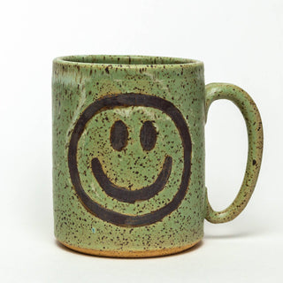 Smiley Face Handmade in Ohio Ceramic Green 14oz Mug - Holt x Palm -  This beautiful green mug with a smiley face hand-painted onto it, approximately 14 oz. This mug is hand-thrown and hand-glazed in Ohio, USA. Food, dishwasher, and microwave safe. It measures approximately 3 1/2 inches wide and 4 inches high. All our ceramic items are handmade and will vary from one to the next. No 2 pieces will be exactly the same. Colors may vary slightly.