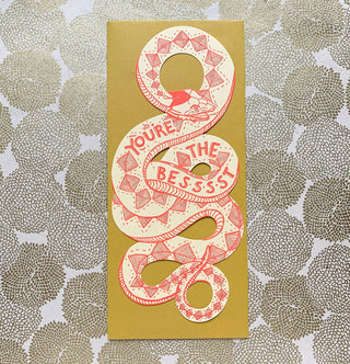 You're The Best Snake Card - Holt x Palm -  This snake card is truly the coolest way to let someone know they're simply the best. Perfect for any occasion, it's a fun and quirky way to show your appreciation. Who knew a snake could be so heartwarming? (No, really. It's super cute!) • flat shaped card is letterpress printed in bright coral ink on 100# manilla yellow paper • measures approximately 4”x8.75” • die cut & cut to hold a gift card, money, tickets, or a love note • accompanied by a #10 envelope