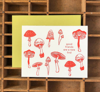 Mushrooms Friendship Card - Holt x Palm -  Friends are a rare find! A perfect card for a best friend, lover, team member, and for basic happy thoughts & friendship. Illustrated by Élise Lassonde, the mushrooms are drawn as a study of specimens. • blank inside and measures 4.25”x5.5” folded • folded card is letterpress printed in warm red ink on 100% cotton paper• accompanied by an A2 chartreuse envelope and packaged in a clear sleeve
