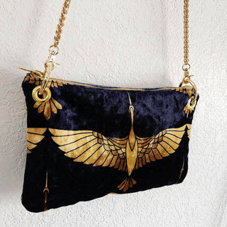 Black and Gold Heron Chain Strap Crossbody Bag - Holt x Palm -  The Black and Gold Heron Crossbody Bag is a beautiful piece to add on your hip. It's slightly smaller than the larger version however still packs a punch. The vintage vibes and crushed velvet exterior offer a touch of elegance, while the large inside pocket and gold velvet lining provide practicality. Made with high-end swivel hardware and an Italian metal zipper closure for a sophisticated finish. *Dimensions approximately 6" H x 9.5" W.