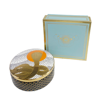 Cobra Rising Ceramic Trinket Box - Holt x Palm -  Not just any storage box, this Cobra Rising Ceramic Trinket Box is super cute and perfect for all your small items. The cobra design adds an awesome touch to this glass box, making it a must-have for any quirky collector. 4.5" Dia, 1.5" H Decorated with 22 kt gold. High-fired porcelain with gold accents Removable lid Boxed for gifting or storing