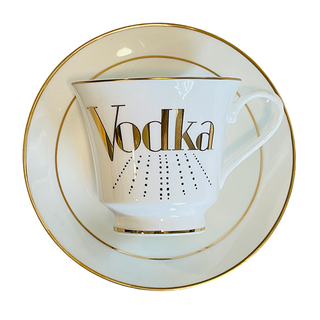 Vodka Tea Cups - Holt x Palm -  "Spice up your tea time with these Vodka Tea Cups! Perfect for any girl who loves a little girl power, these cups feature elegant gold accents and even come with a saucer. Because who says tea time can't be a little fun and quirky? Cheers to that! (Pun intended)" Dishwasher safe Cup Measures 6" Cup 3.5" w 3.10 h
