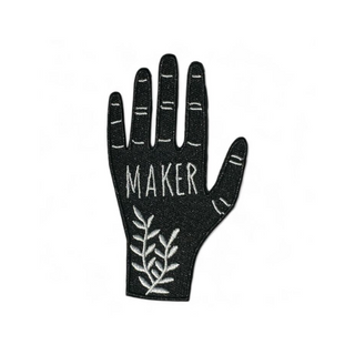 Hand Maker Patch - Holt x Palm -  A hand-shaped patch with the word "maker" on the palm along with ferns adorning the wrist. Based on a linocut print by ilikesara / Sara Schalliol-Hodge. -black & white -2.56" x 3.9" -iron-on backing instructions for ironing: Place the patch on your garment and cover the patch with a piece of fabric. Iron on high heat for 30-45 seconds. Turn the garment inside-out and iron on reverse side of the patch for 30-45 seconds.