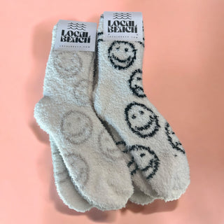 Smiley Local Beach Cozy Socks - Holt x Palm -  Introducing the Local Beach Cozy Sock Collection. Warm and Fuzzy incredibly cozy crew slipper socks. Feather Knit construction with an ultra soft hand. Perfect for home, travel, and beyond. Cozy up and stay warm with the softest socks ever. 100% Polyester Microfiber One Size Fits Most No fading, shed free Care: Machine Wash Cold, Gentle Cycle. Air or tumble dry low