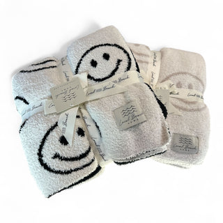 Smiley Luxe Home Blanket - Holt x Palm -  Introducing the Local Beach Home Collection featuring luxurious and incredibly cozy XL blankets. Reversible 100% Feather Knit construction with an ultra soft hand. Perfect for home, travel, and beyond. Cozy up and stay warm with the softest blanket ever. 100% Polyester Microfiber Reversible =Top side is light color, bottom side is dark color XL Blanket, Double layer 54" W x 72" L No fading, shed free Care: Machine Wash Cold, Gentle Cycle. Air or tumble dry low