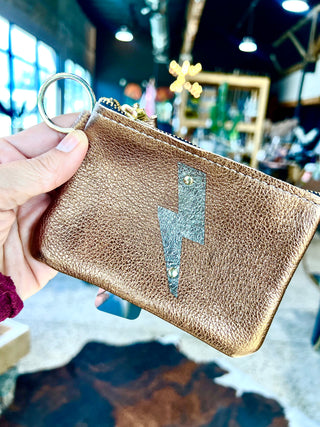 The Cutest Up-Cycled Leather Lightening Bolt Pouch You Ever Did See.... - Holt x Palm -  We love these little pouches!! They just keep your purse organized in style. Use them for Airpods, cash, ID, pills, whathaveyou! It's your little good time pouch...attach it to your purse or just your belt buckly and go out and have you a good 'ol time! Buy a few for friends...they will adore them! DETAILS: Measures 5"x3.5". Unlined. Brass zipper and key ring Appliques are hand cut and attached with mini rivets.