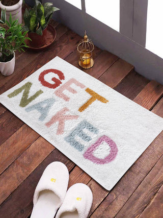 GET NAKED! Bath Mat - Handtufted - Holt x Palm -  Get ready to get naked (on your feet at least) with our fun bath mat! Perfect for adding some playfulness to your bedroom or bathroom. Who says getting clean can't be fun?! SIZE : 20 X 30 Inches// 51 X 76 CM SHAPE : Rectangular Color : Multi Colors Material : Soft Hand Spun Cotton MAKING :