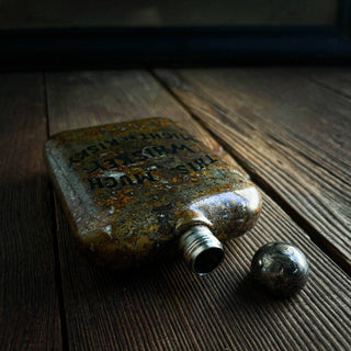 RISKY WHISKEY FLASK - Holt x Palm -  Add some risk to your whiskey with our Risky Whiskey Flask. Keep it fun and manly with this perfect accessory for the whiskey drinker in your life. Bring it to all your adventures and never worry about taking yourself too seriously. Cheers to a good time! 6 oz stainless steel with etched embellishments atop our classic patina.