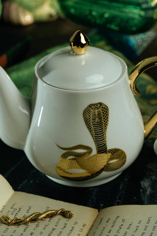 The Most Adorable Cobra Teapot w/ Gift Box - Holt x Palm -  Sippin' tea never looked so cool! Check out our ceramic 24K gold laced Cobra tea-pot...pair this beauty with one of our Poison or Queen tea cups and you have the most unique and unexpected gift for someone amazing...or yourself :-). You deserve it! Plated 24K gold material from Germany. 6" H (including lid) 6" L (handle to spout) 5" W.