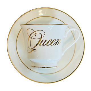 The Queens Tea Cup w/ Gift Box - Holt x Palm -  Regale yourself in the luxury of our newest collection of fine Bone China from Spitfire Girl. Do you want to treat her like the Queen she is? Or treat yourself because you are a Queen that only deserves the best. All Teacups come with a cup and saucer and are packaged in an elegant blue gift box with 24K gold accents. Plated 24k gold material from Germany Dishwasher safe Cup measures 6" Cup 3.5" w 3.10 h