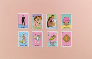 Millennial Loteria: Gen Z Edition - Holt x Palm -  Gen Z is changing the game. Again. Ditch the skinny jeans and side parts with the new Gen Z Edition of Millennial Lotería. With new cards like El Simp, La Middle Part, and El Toxic, it's a brand new take on the best-selling Latino card game that reflects a new, NEW generation. No cap, you're gonna love this game. Period. Millennial Loteria Gen Z Edition Includes: 46 cards * 10 boards * 108 emoji tokens