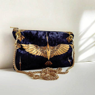 Black and Gold Heron Chain Strap Crossbody Bag - Holt x Palm -  The Black and Gold Heron Crossbody Bag is a beautiful piece to add on your hip. It's slightly smaller than the larger version however still packs a punch. The vintage vibes and crushed velvet exterior offer a touch of elegance, while the large inside pocket and gold velvet lining provide practicality. Made with high-end swivel hardware and an Italian metal zipper closure for a sophisticated finish. *Dimensions approximately 6" H x 9.5" W.