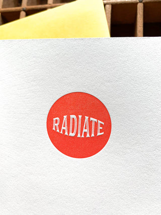 You Radiate Pure Awesome Card - Holt x Palm -  "Spread smiles and pure awesome vibes with this playful greeting card. Perfect for showing your rad friends and loved ones how much they mean to you. Get ready to make someone's day!" • blank inside and measures 4.25”x5.5” folded • folded card is letterpress printed in warm red and yellow ink on 100% cotton paper • with circle die cut on front • accompanied by an A2 yellow envelope