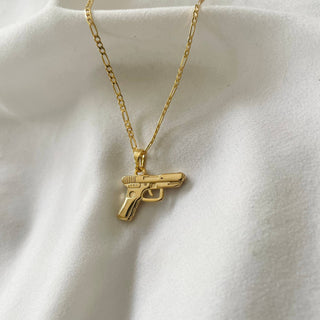 Bang Bang 24k Gold Gun Chain Necklace - Holt x Palm -  Get ready to turn heads with the Bang Bang 24k Gold Gun Chain Necklace. This super cool accessory is gold filled, giving it a stunning shine that will keep you looking fly. Channel your inner boss and keep it G with this one-of-a-kind piece. 17.5” Figaro chain