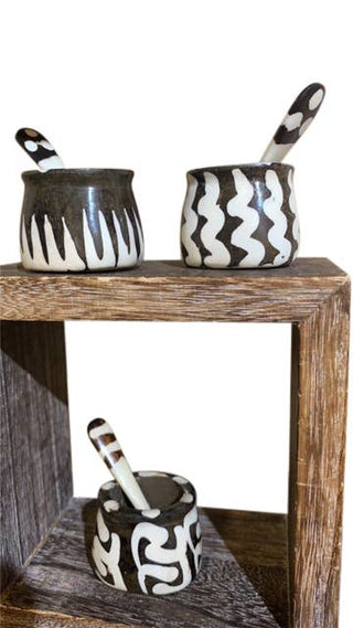 Batik Bone Spice Pot - Holt x Palm -  Our lovely little Spice Holder set delivers big rewards in terms of style. Batik Colors may Vary! Hand-crafted from exotic Bone sourced sustainably in East Africa, this table or barware sets the scene with lush tones and textures. Decorated with a traditional design, they are a top option for your gift list too. Set of 2 ( Pot & Spoon) Color - Batik Paint Material - Cattle Bone Size - 2" High x 1" Diameter
