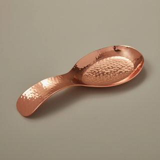 Camden Spoon Rest - Holt x Palm -  Indulge in rustic copper accent pieces that warm and brighten the home with our hammered copper spoon rest. A bold addition to any kitchen, each is handcrafted by master artisans to produce its unique rippled texture and imbued with a food-safe coating. Measurements: 8.5" x 3" x 1" Assembled by hand in India. Ethically crafted in small batches. CARE INSTRUCTIONS: Hand wash with mild soap. Avoid citrus-based detergents or abrasives to preserve unique finish.