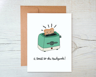 Retro Toaster Wedding Card - A Toast to the Newlyweds! - Holt x Palm -  Retro Toaster Wedding Card - A Toast to the Newlyweds! DESIGN: Digital art created in Procreate MATERIALS: Printed on 110# white cardstock. Includes a craft paper envelope SIZE: A2, folded INSIDE: Blank inside