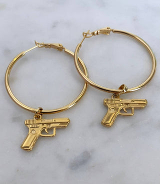 Bang Bang 24k Gold Gun Hoop Earrings - Holt x Palm -  Spice up your life with these Bang Bang 24k Gold Gun Hoop Earrings! These gold filled hoops bring the big hoop energy and a touch of luxuriousness to any outfit. Keep it G and make a statement with these unique and playful earrings. 1.75" Diameter